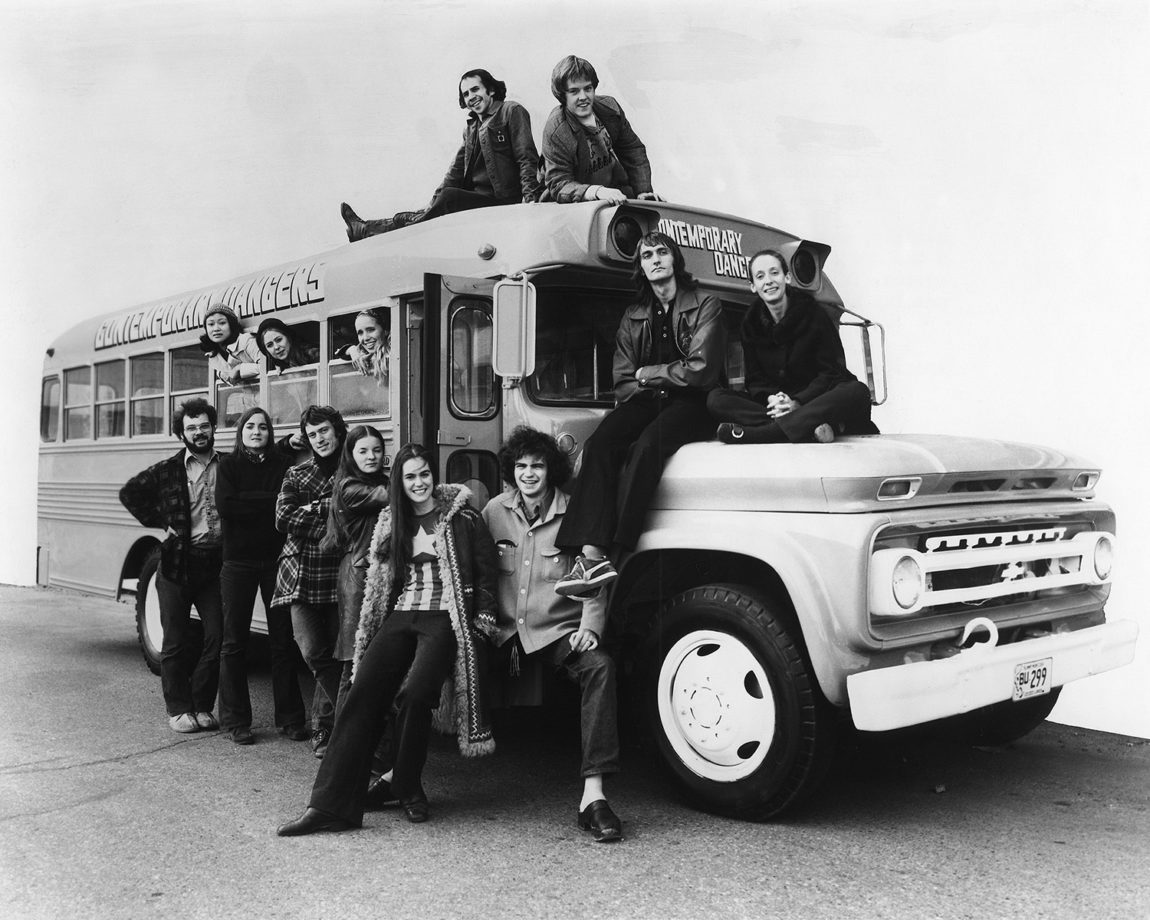 WCD Tour Bus, 1971 In photo: (in the windows, L-R) Elaine Loo, Michele Presley, Holly Anne Savage; (Standing, L-R) 2 crew members, David Tucker, Barbara Johnson, Janet Oxley, Jim Green; (on roof L-R) David Weller, Charlie Moulton; (on hood, L-R) Larry Brinker, Rachel Browne Photographer: Unknown